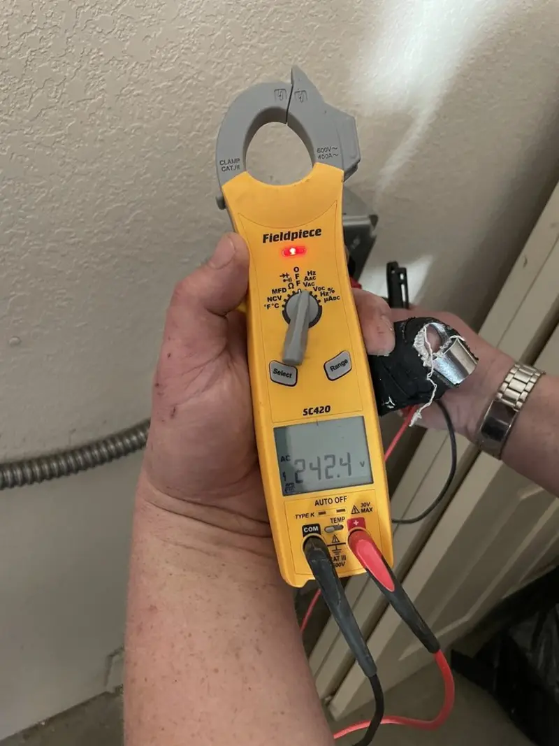 Voltage testing with clamp meter during Recessed Lighting Installation in Cloverdale
